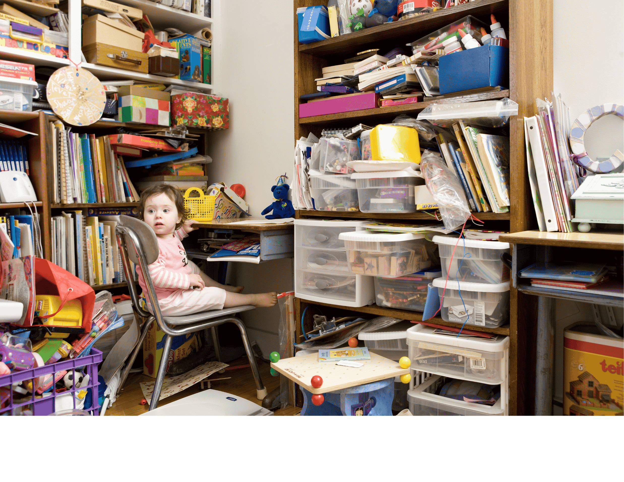 child in cluttered room